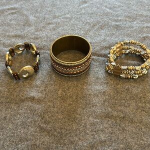 Set of 3 mixed metals bracelets by Chicos. 2 are stretch and one is a bangle